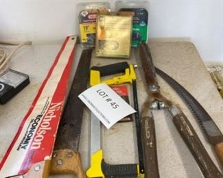 Lot of hand saws, 3 chainsaw chains, hedge trimmers.