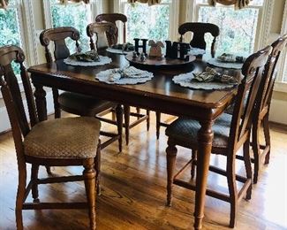 High square dining table with 8 chairs priced at $899.00 measuring 60" square w/ 20" leaf insert. Normal wear and tear.