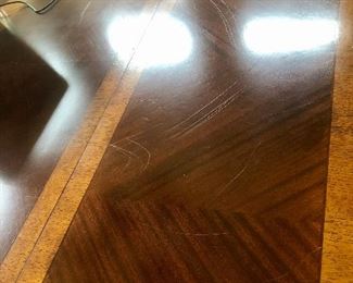 Scratches on the table. The top does have imperfections and priced to reflect such. Still a beautiful table!