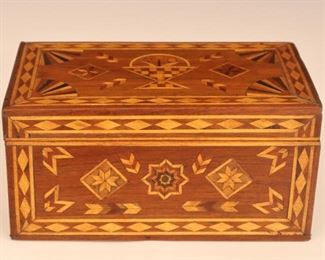 Lot 41: A late 19th century American Folk Art box.  Walnut box with all over inlaid decoration in Maple, Walnut, Mahogany and Ebony with Flower basket on the lid.  Old finish with minor wear, minor shrinkage.  15 1/4 x 10 x 5 3/4" high