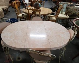 Vintage bistro style mid century modern pink laminate table, leaf  & 4 chairs. 2 of the chairs have some damage to seat cushion. Table measures approx : 42" in diameter with leaf 59"  Was $695 Now $375