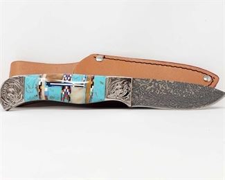 915	

Navajo Style Engraved Boot Knife with Turquoise and Multicolor Inlay Handle and Leather Sheath
Has approx 3" blade and measures approx 9.5" over all 