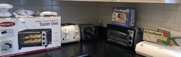 Kitchen Lot #10 New Toaster Oven $25.00, White Toaster $10.00, Stainless Toaster $5.00, Electric Knife $5.00, Can Opener $3.00, Toaster Oven (used) $8.00, Kenmore Food Saver $20.00