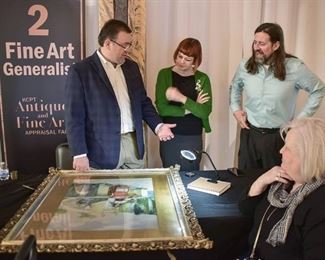 Jason Roske, Amy Abshier and Justin Rogers appraising a painting at the KCPT Antique and Appraisal Fair.