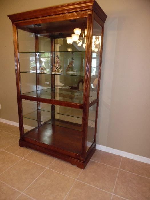 Price $600. Howard Miller Display Cabinet,  Full Glass front slides each way. 