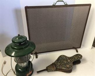 Fireplace screen, antique bellows, and Coleman lantern