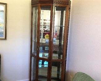 Corner Curio Cabinet $250.00.  Lit on both the top and bottom(see pictures).  Dimensions 80" Tall X 34" Wide X 15" Deep.  
