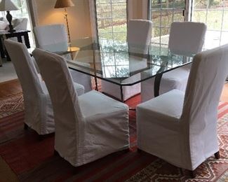 Glass top table with metal base  72" w x 43"w  $199.00  Set of six Pottery Barn slipcovered chairs, including extra set of slipcovers in tan $59.00 ea., take all ($354.00)  one white slipcover has faint stain.  As is