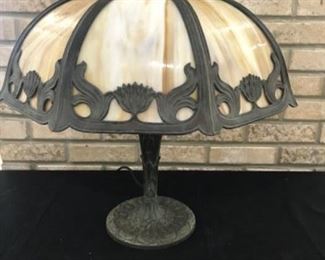 $250 up for sale is a beautiful slag glass lamp. Lamp has been re-wired and in my opinion the cords is tad bit short it is a nice cloth cord. The shade mount is new and has been painted to a close match but not exact to the rest of the lamb.The lamp is 20 1/2 inches tall the shade is 7 1/4 inches tall and approximately 18 inches across from flat side to flat side.