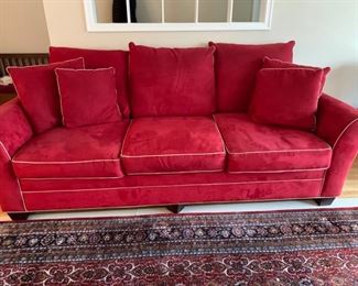 Now $185! - $250- Super comfortable microsuede vibrant red sofa with four matching throw pillows. No manufacture name. No tears in fabric, but two staining issues- one on the back left arm and the middle cushion has a stain and has been turned upside down. (see all photos)  Has light tan piping. Measures approximately 103.5" long by 42" deep and 30.5" tall in the back and 27" tall in front. The cushions measure 30" deep 26.5" wide. 