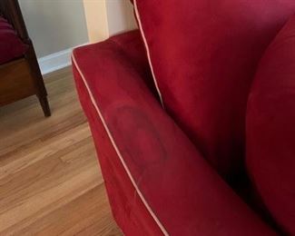 Now $185! ----$250- Super comfortable microsuede vibrant red sofa with four matching throw pillows. No manufacture name. No tears in fabric, but two staining issues- one on the back left arm and the middle cushion has a stain and has been turned upside down. (see all photos)  Has light tan piping. Measures approximately 103.5" long by 42" deep and 30.5" tall in the back and 27" tall in front. The cushions measure 30" deep 26.5" wide. 