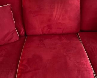 Now $185! ----$250- Super comfortable microsuede vibrant red sofa with four matching throw pillows. No manufacture name. No tears in fabric, but two staining issues- one on the back left arm and the middle cushion has a stain and has been turned upside down. (see all photos)  Has light tan piping. Measures approximately 103.5" long by 42" deep and 30.5" tall in the back and 27" tall in front. The cushions measure 30" deep 26.5" wide. 