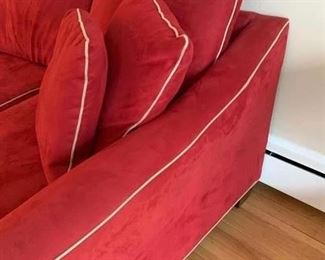 Now $185! -$250- Super comfortable microsuede vibrant red sofa with four matching throw pillows. No manufacture name. No tears in fabric, but two staining issues- one on the back left arm and the middle cushion has a stain and has been turned upside down. (see all photos)  Has light tan piping. Measures approximately 103.5" long by 42" deep and 30.5" tall in the back and 27" tall in front. The cushions measure 30" deep 26.5" wide. 