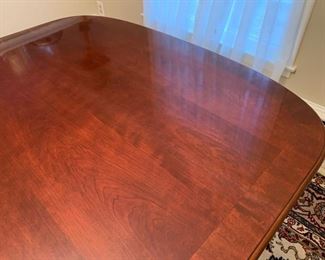Now $150!  $195 -Very nice large dining room table and six chairs. Approximately 68" x 43" wide with the leaf adding 15" (two leaves measuring 15" each) One noticeable "ding" on the top. (ding measures approximately .75" long by .25" wide) Table is cherrywood with a veneer top and has rounded corners and an inlaid design. 