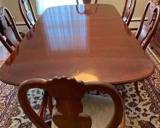Now $150!   $195 -Very nice large dining room table and six chairs. Approximately 68" x 43" wide with the leaf adding 15" (two leaves measuring 15" each) One noticeable "ding" on the top. (ding measures approximately .75" long by .25" wide) Table is cherrywood with a veneer top and has rounded corners and an inlaid design. 