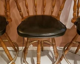 $40-Set of 4 wood and black leather barstools. Measure 42" high and 20" width between arms, seat is 31" high. Scuffed wood on all upper wood chair backs. 2 seats with slight damage 
