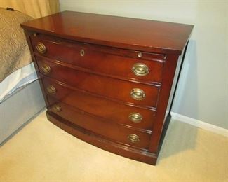Vintage mahogany bow-front bachelor's chest with pull out tray. (Condition note: imperfection to finish on top as seen in additional photo). 37"w X 31.75"h X 19"d PRICE: $150.00