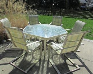 Outdoor patio table with (6) armchairs. 54.25" diameter hexagon X 27.75"h ; (6) chairs 24"w X 40"h X 30"d. (condition note: chairs in need of cleaning and paint touch up as seen in additional pictures). PRICE: $150.00 for set
