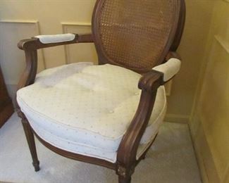 French-style arm chair with caned back. 23"w X 34.5"h X 20.25"d PRICE: $100.00