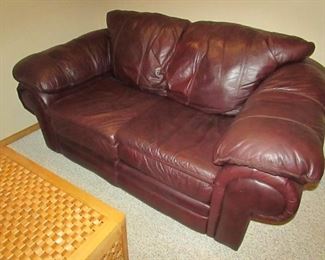 Faux leather loveseat. 70"w X 36"h X 37"d PRICE: $195.00
