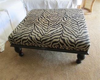 Large ottoman with animal print upholstery and nail heads. 40"w X 18"h X 36"d. PRICE: $100.00