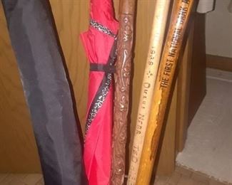 ASSORTED UMBRELLAS AND CANES WITH VINTAGE TRASH BIN