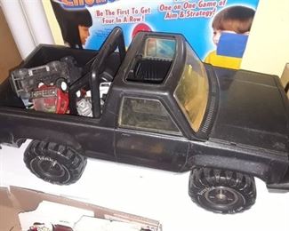 BLACK TONKA TRUCK WITH VARIOUS TOY CARS