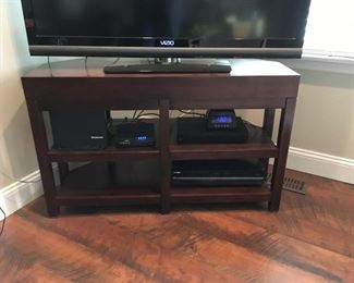 Dark wood corner TV stand.  It is 42" across, 18" deep and 26" high.  Perfect for organizing electronics in a stylist manner.  $130.  New price $95.  Make an offer!