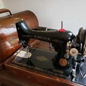 Old Antique sewing machine that powers on and goes with knee bar. Light is working too.