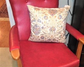 One of two red leather chairs