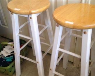Two white bar stools
