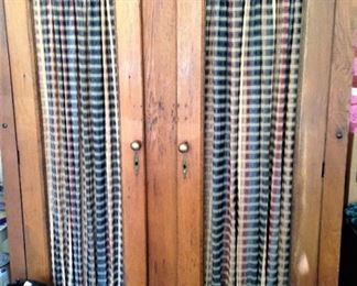 Antique armoire with fabric panels