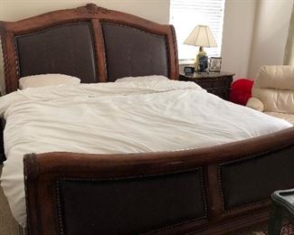 King sized leather inlay sleigh bed(does not include mattress/ does include box spring). $500.00.  Dimensions:  Headboard...68 high x 82 wide.  Footboard 33 high x 82 wide