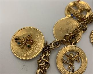 14K Charm Bracelet with 14K charms. Some are jeweled with diamonds and gemstones. It is 7.5 inches long and weighs just over 60 grams TW $2250.00 #253