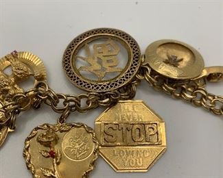 14K Charm Bracelet with 14K charms. Some are jeweled with diamonds and gemstones. It is 7.5 inches long and weighs just over 60 grams  TW $2250.00 #253