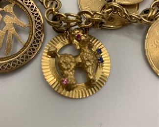 14K Charm Bracelet with 14K charms. Some are jeweled with diamonds and gemstones. It is 7.5 inches long and weighs just over 60 grams  TW $2250.00 #253