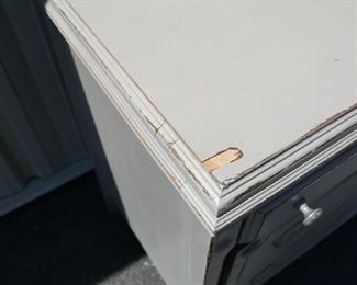small peeling of veneer on front left of dresser