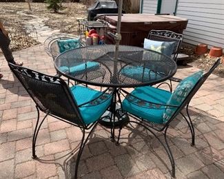 Patio set with umbrella and four chairs 
$175.00