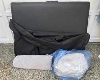 Anbber massage table with heating pad and fitted sheet. It has a small hole ( photo) bag carrying case has rib as well . $55.00