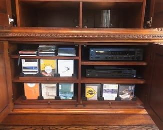 Entertainment Center, Solid wood, hand carved - 101”wide x 86” high at midpoint  x 24.5” front to back (deep). Lights inside of 
each tower - touch on via hinge, $975