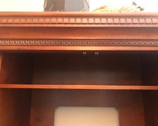 Entertainment Center, Solid wood, hand carved - 101”wide x 86” high at midpoint  x 24.5” front to back (deep). Lights inside of 
each tower - touch on via hinge, $975