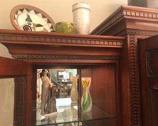 Entertainment Center, Solid wood, hand carved - 101”wide x 86” high at midpoint  x 24.5” front to back (deep). Lights inside of 
each tower - touch on via hinge, $975