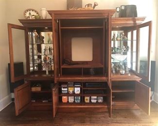 Entertainment Center, Solid wood, hand carved - 101”wide x 86” high at midpoint  x 24.5” front to back (deep). Lights inside of 
each tower - touch on via hinge, $975