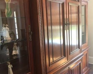 Entertainment Center, Solid wood, hand carved - 101”wide x 86” high at midpoint  x 24.5” front to back (deep). Lights inside of 
each tower - touch on via hinge, $975