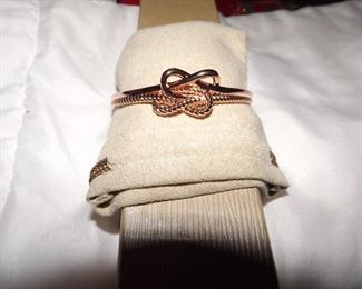 43.   Rose gold bangle bracelet. Knot... $15.00