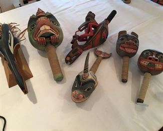 #67 A $250 Gary Peterson 'Nangus Raven' mask on stand; B $75 beaver rattle (cracked back); C $125 orca rattle; D $175 raven on bird rattle; E $125 bear rattle; F $125 rattle on right