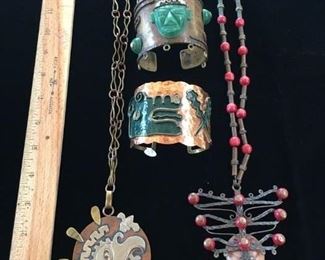 #106 Mexican mixed metals A copper, brass and silver pendant $25; B copper cuff with carved mask $15; C copper brass and enamel cuff SOLD; D carved mask pendant $15