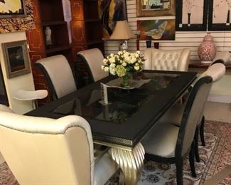Gold leaf dining table with leather and glass top four silk fabric side chairs and two silk tufted arm chairs. Sale price $1150. Glitzy! 