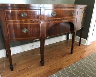 SIDEBOARD, 64” length x 26” depth at center x 36” height - Stunning sideboard/buffet in the style of Hepplewhite complete with spade feet.  