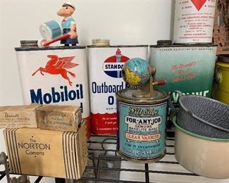 Vintage tins with Popeye on the top checking it out!